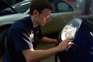 Ranken student working on auto headlight