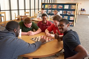 Students relax over a game of checkers in the Student Success Center